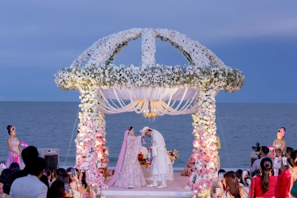 Seaside floral mandap wedding ceremony at dusk